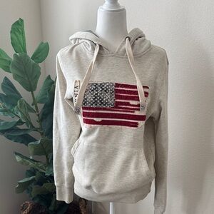 Cream Hoodie with Distressed American Flag Graphic